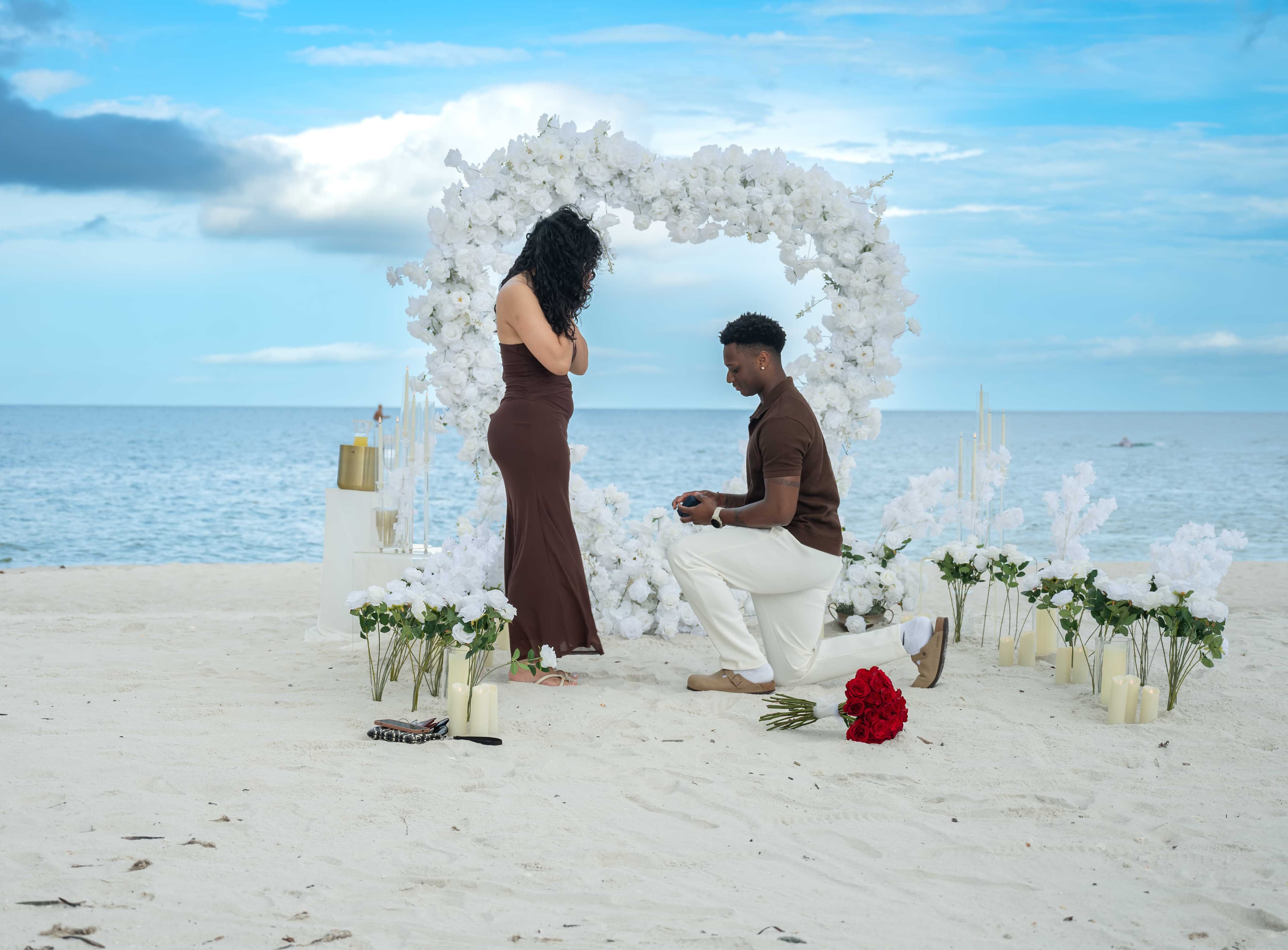 Beach proposal moment under a floral arch, Cape Coral FL