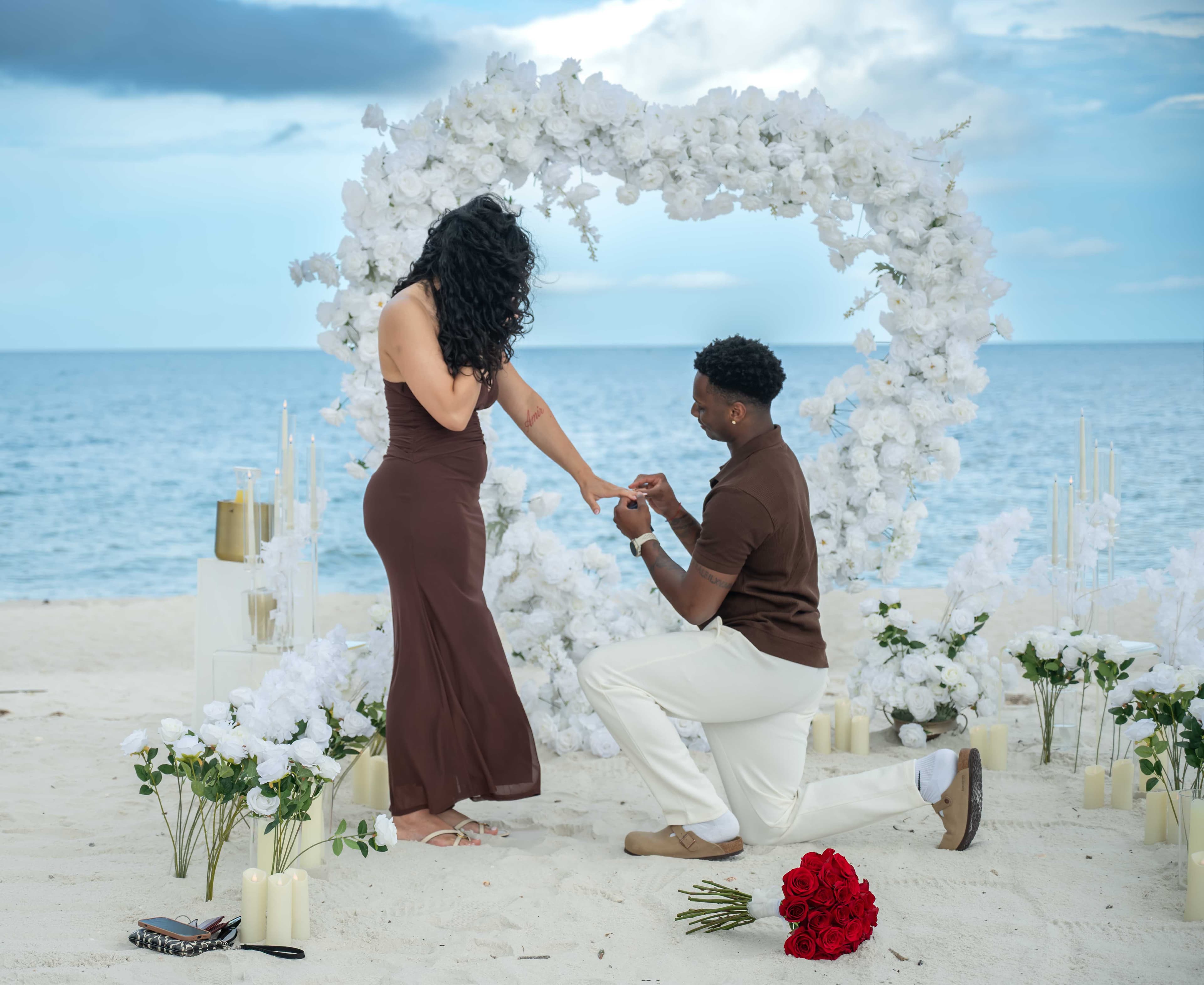 Groom placing the ring on his fiancée after proposing