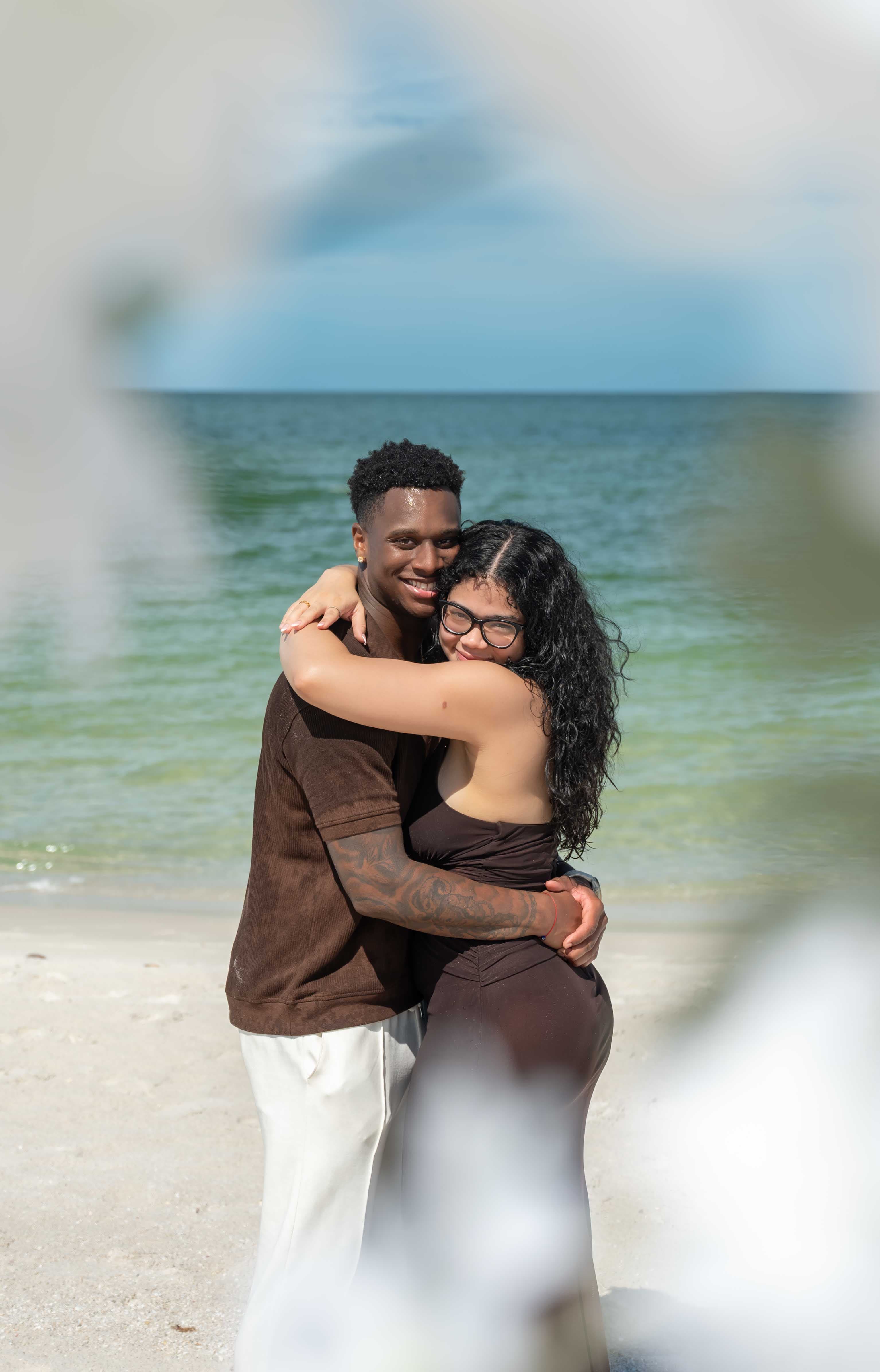 Couple embracing on the beach at golden hour