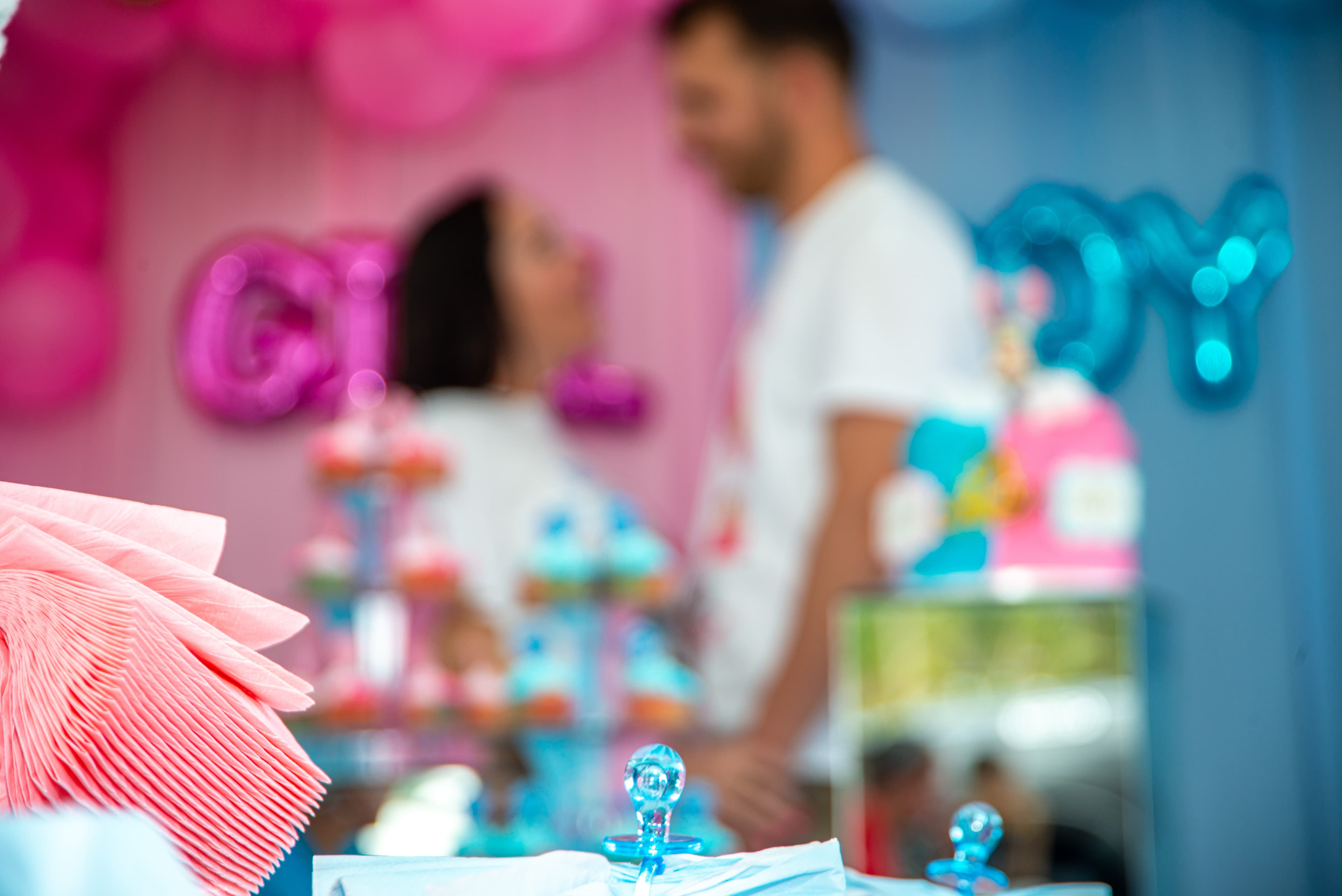 Gender reveal dessert table detail with balloon garland