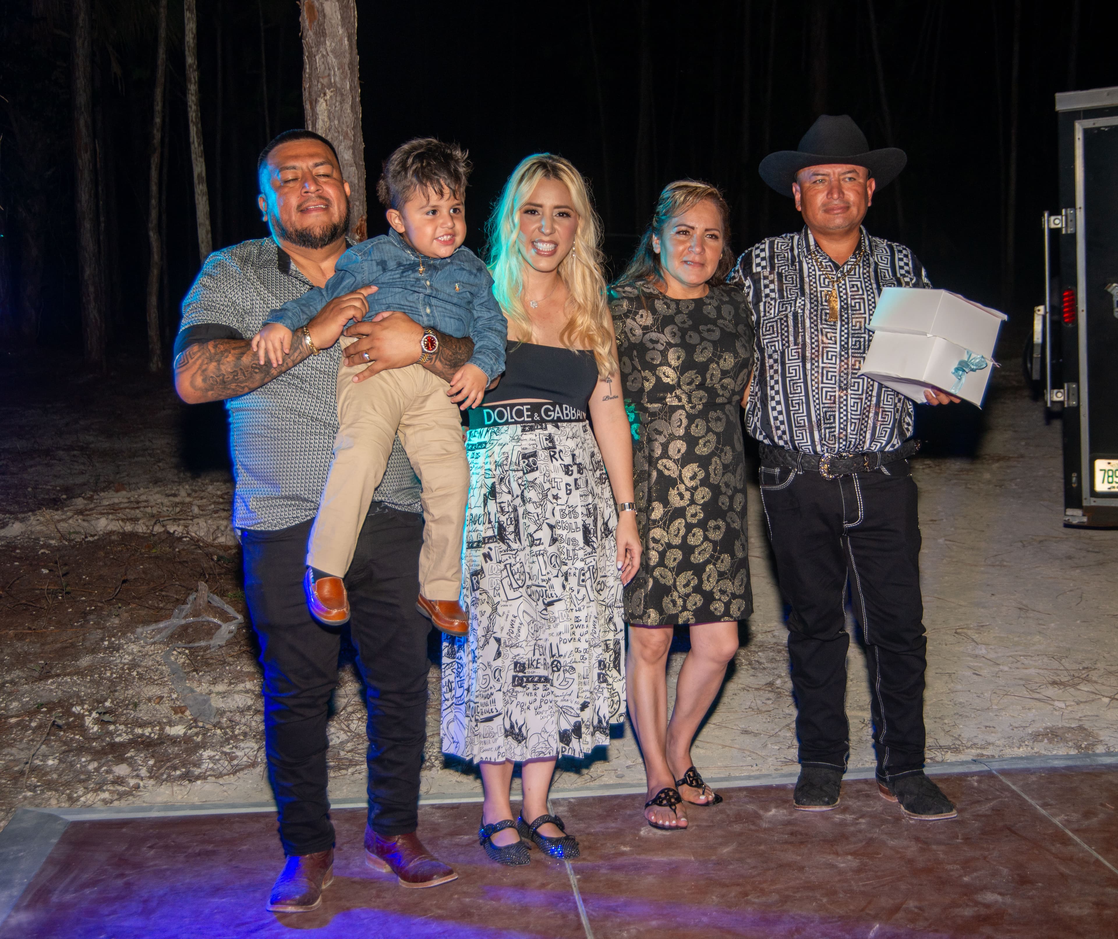 Family group portrait with gifts at an evening celebration