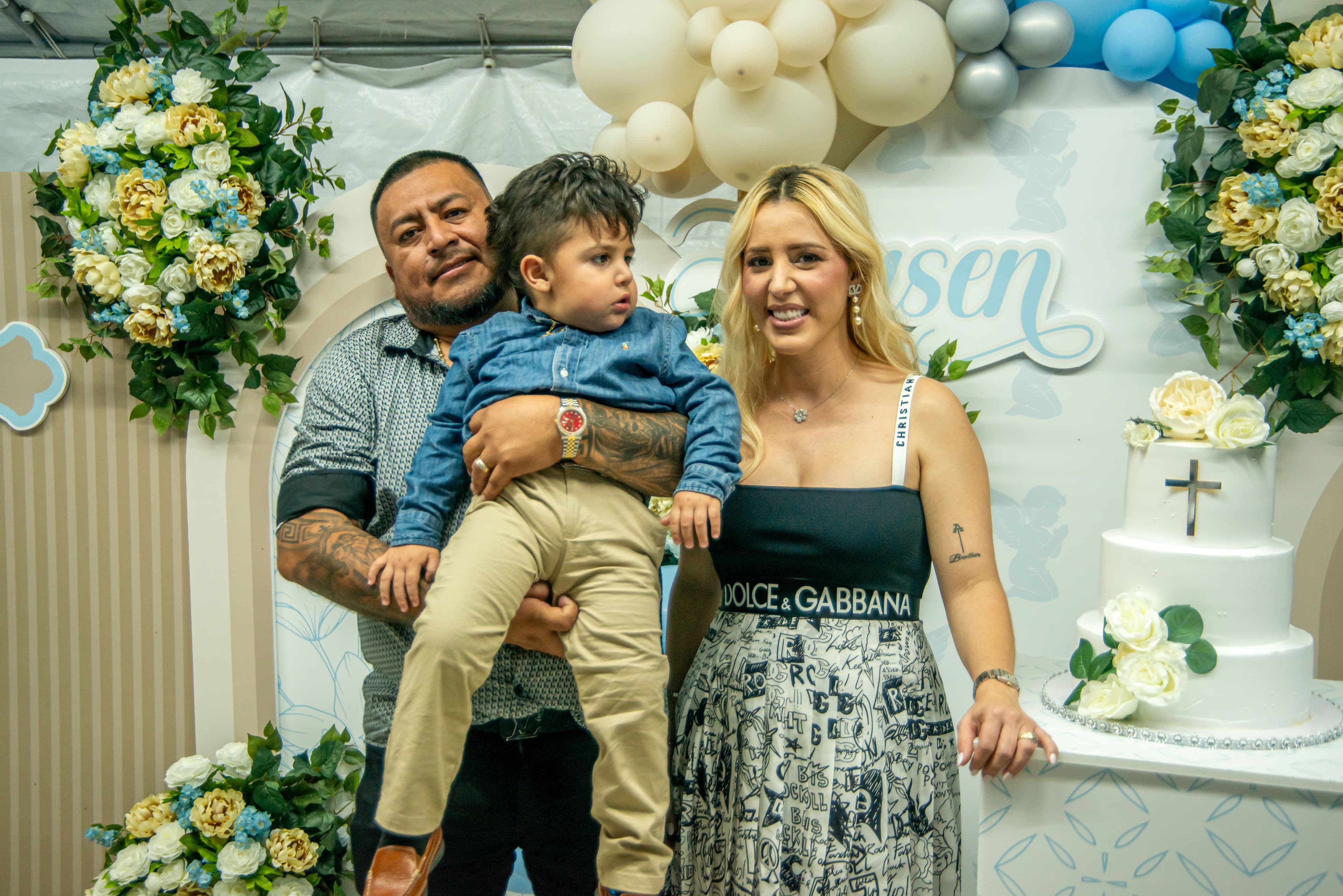 Parents and child posing by the ceremony cake, Cape Coral FL