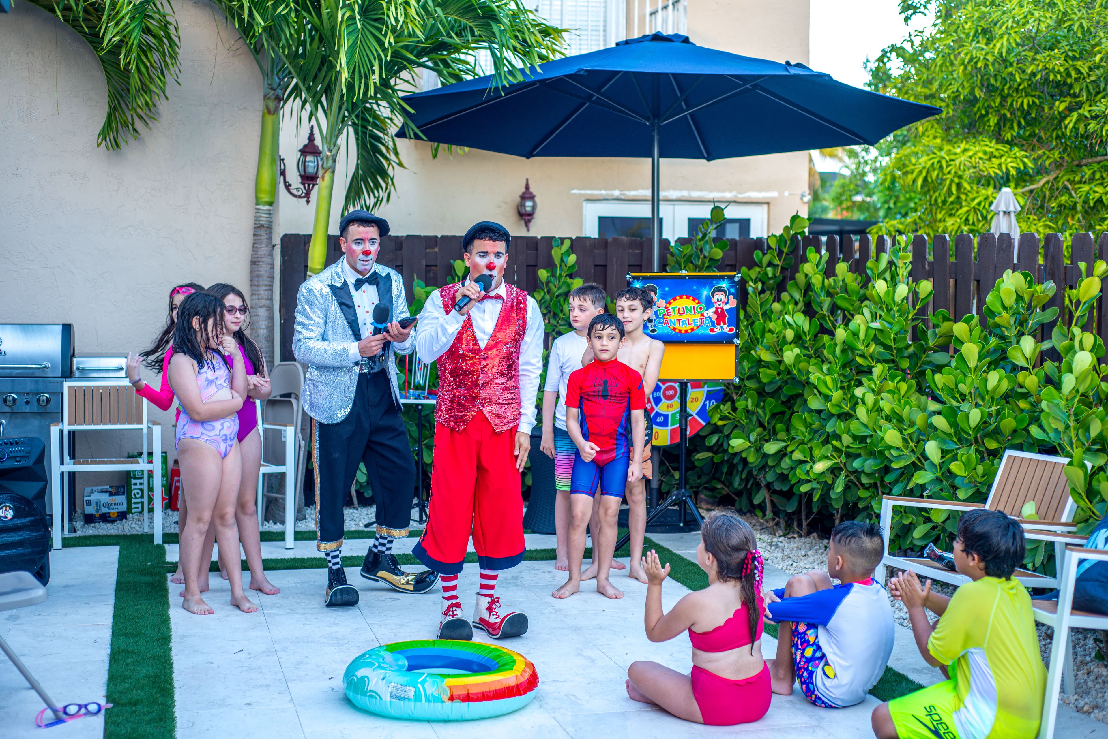 Clown performers singing with kids at a birthday party