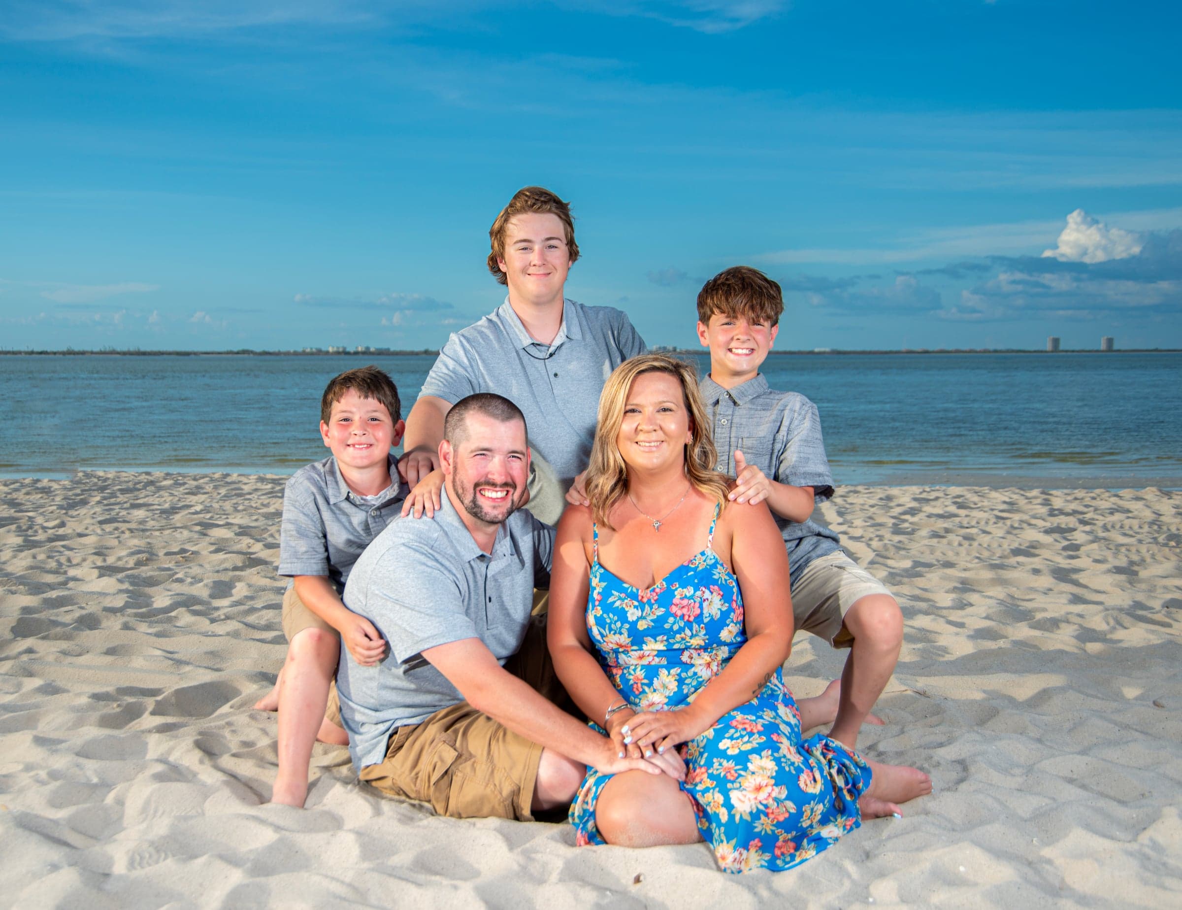Family of five at Southwest Florida beach, blue sky