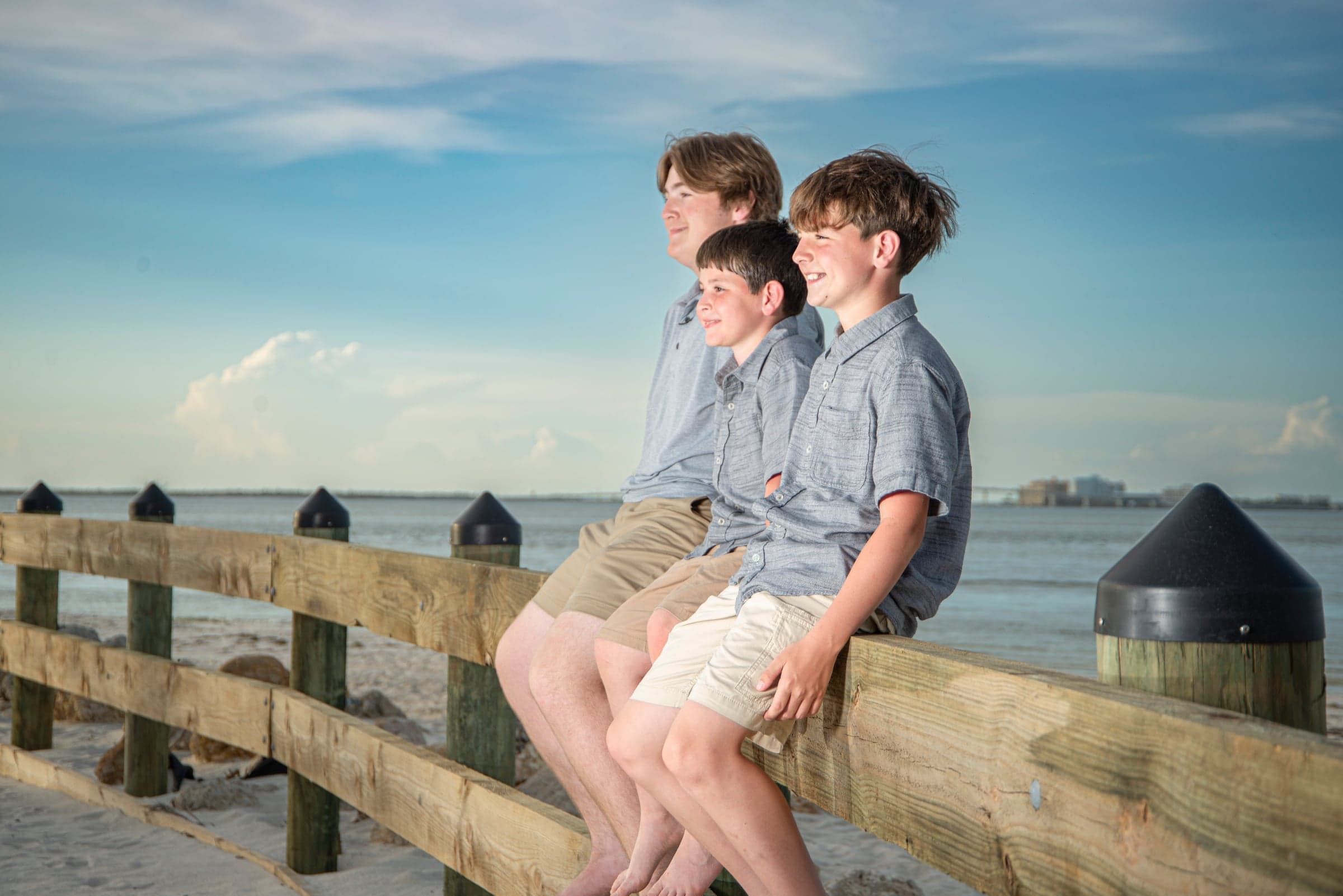 Three brothers sitting on pier, Cape Coral FL photographer