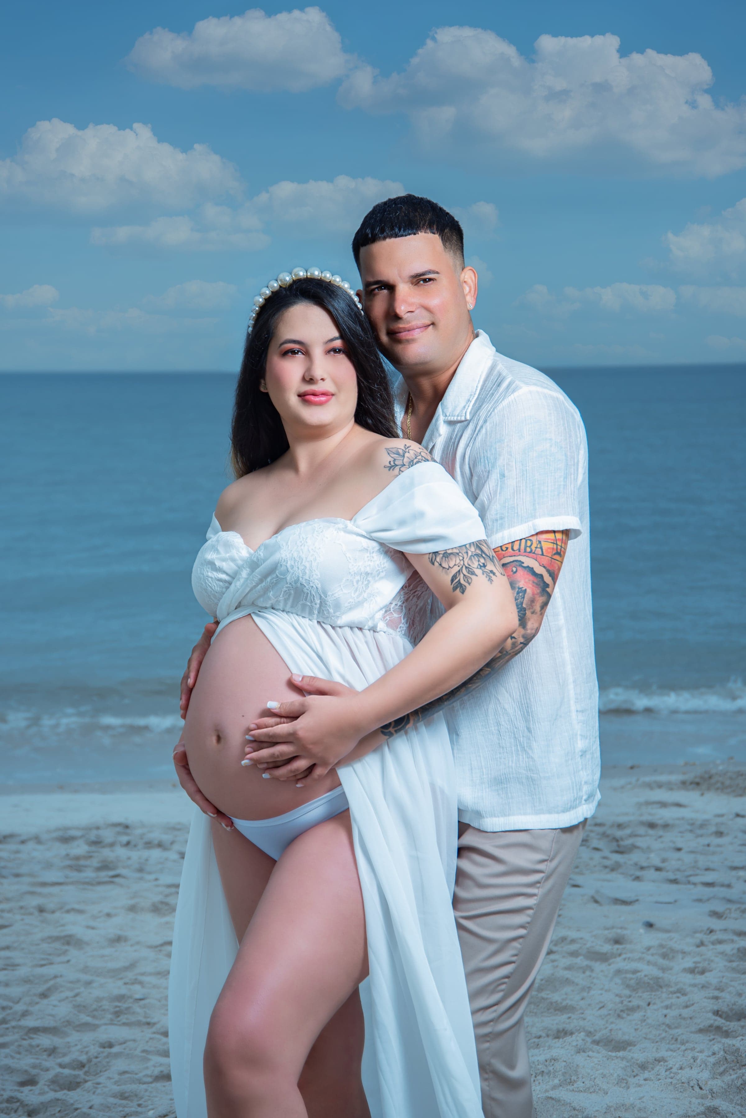 Beach maternity session at Naples pier, blue sky