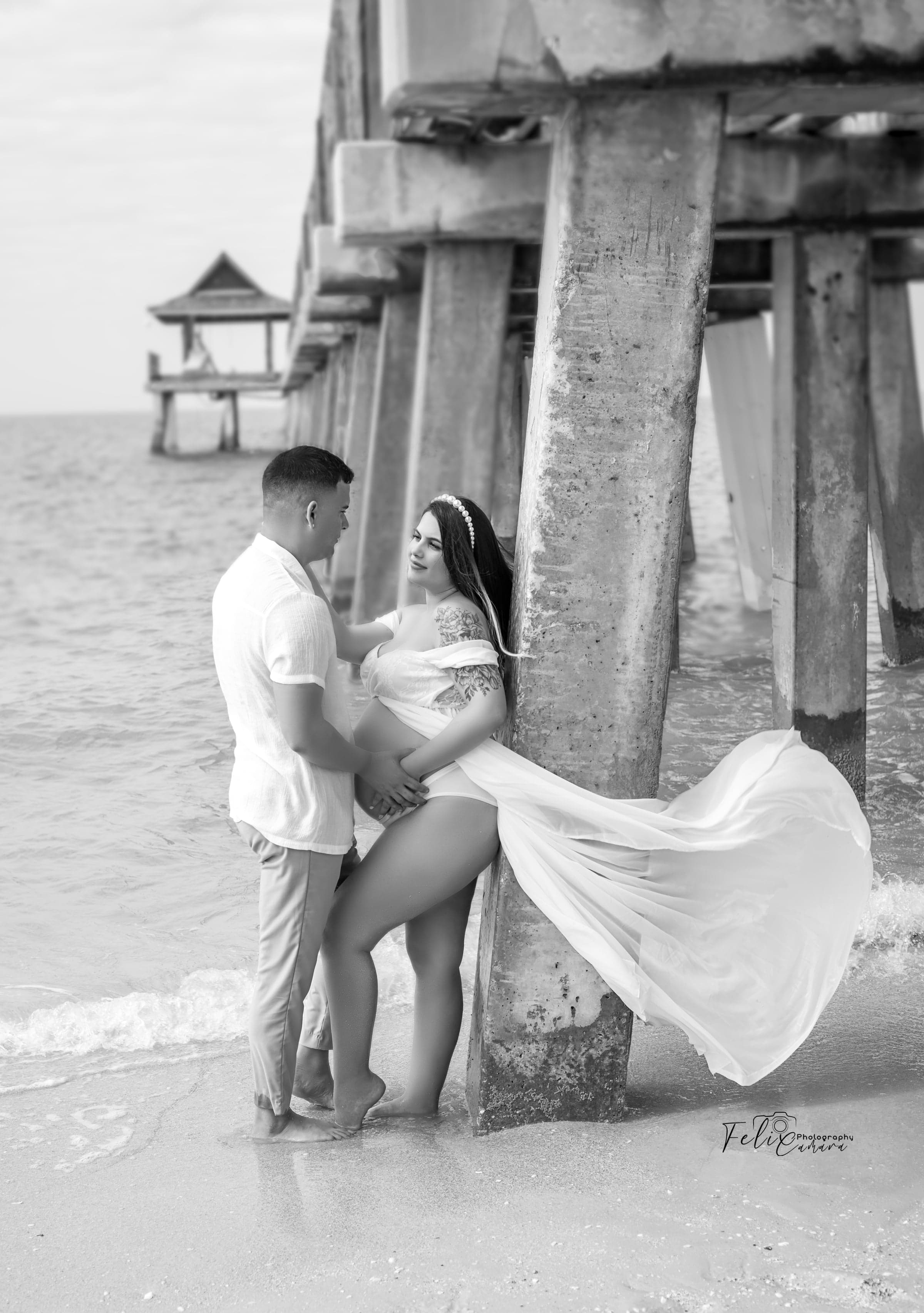 Black and white maternity portrait at pier, Naples FL