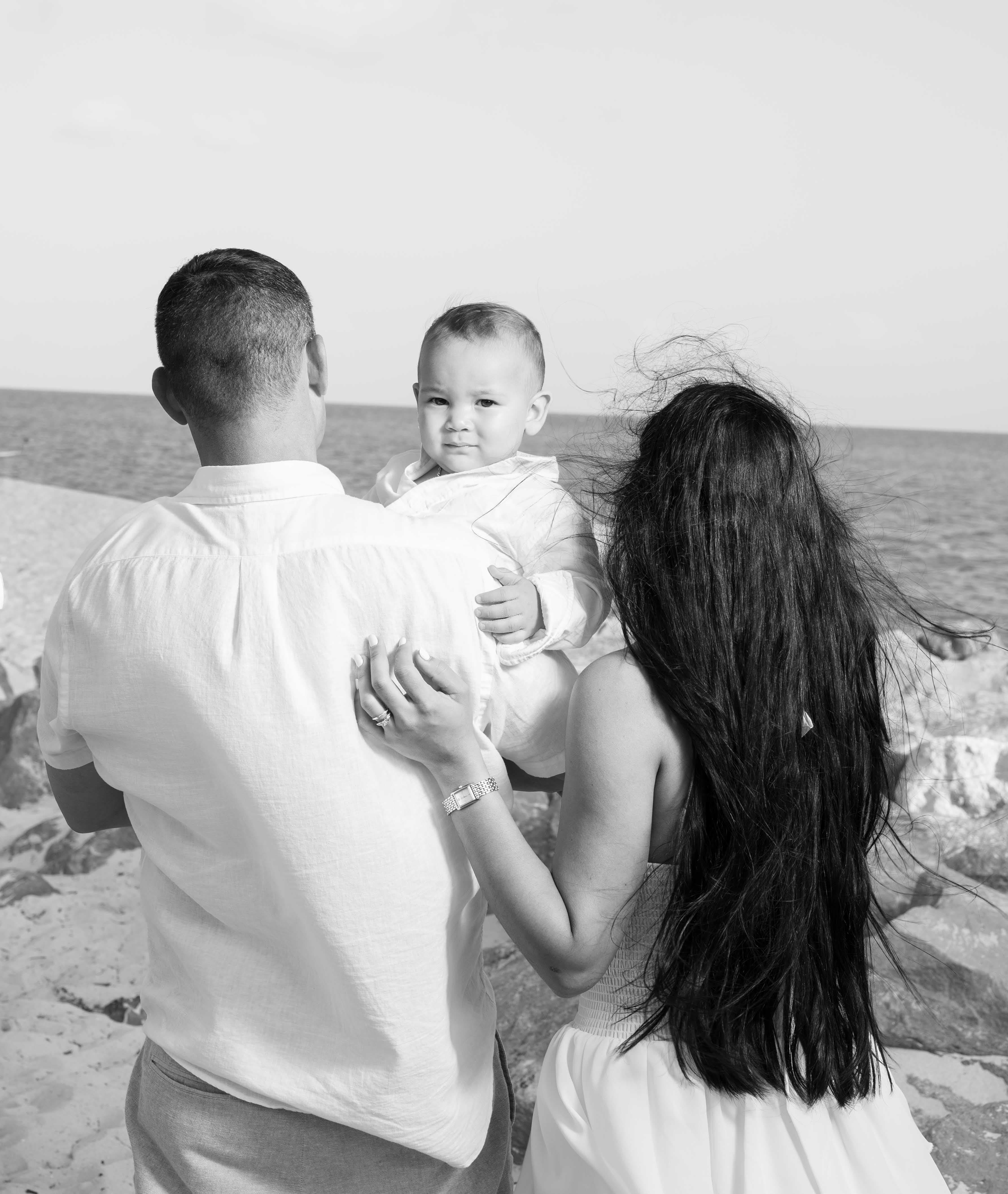 New dad holding his baby daughter on the dock