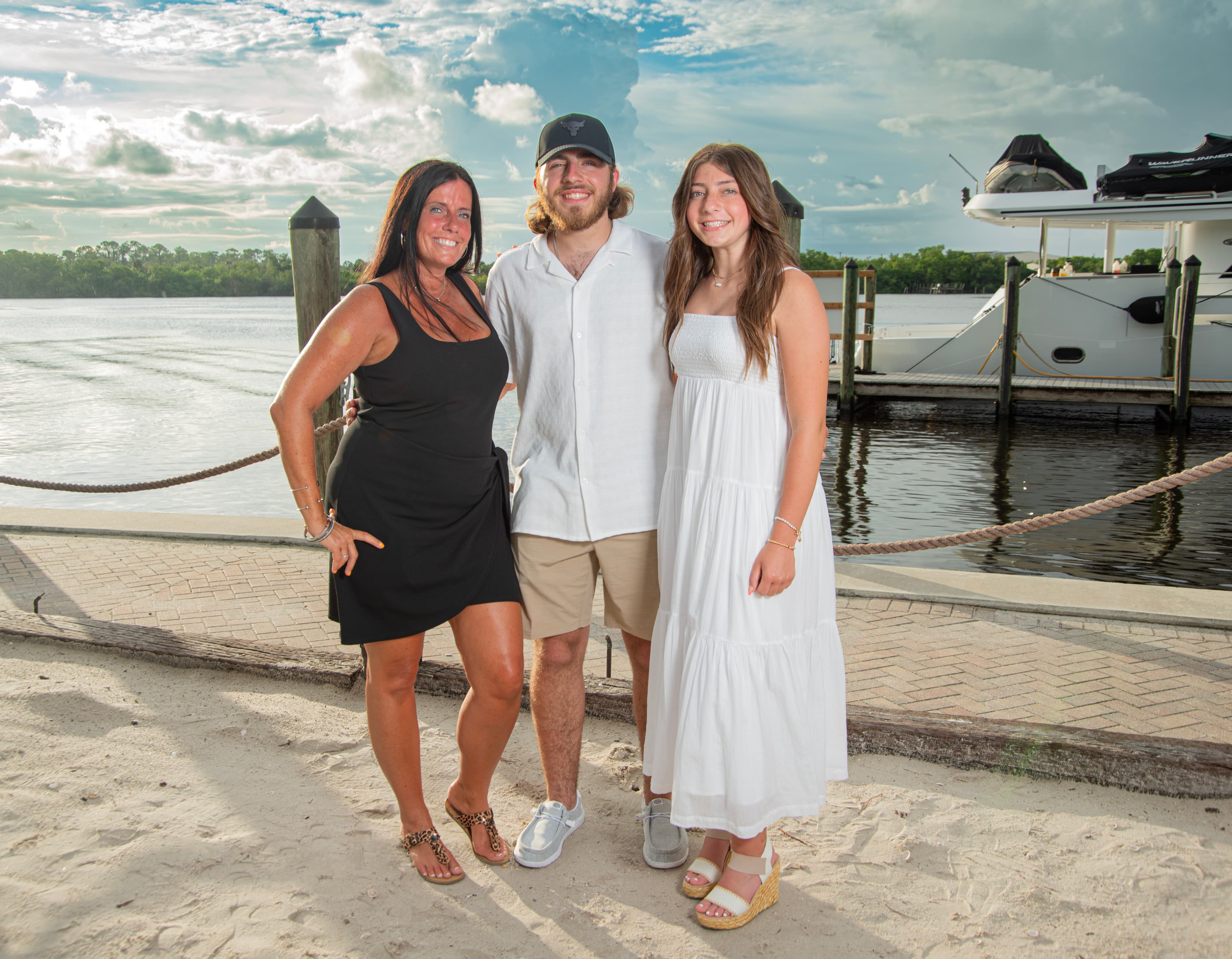 Family portrait by the water at sunset
