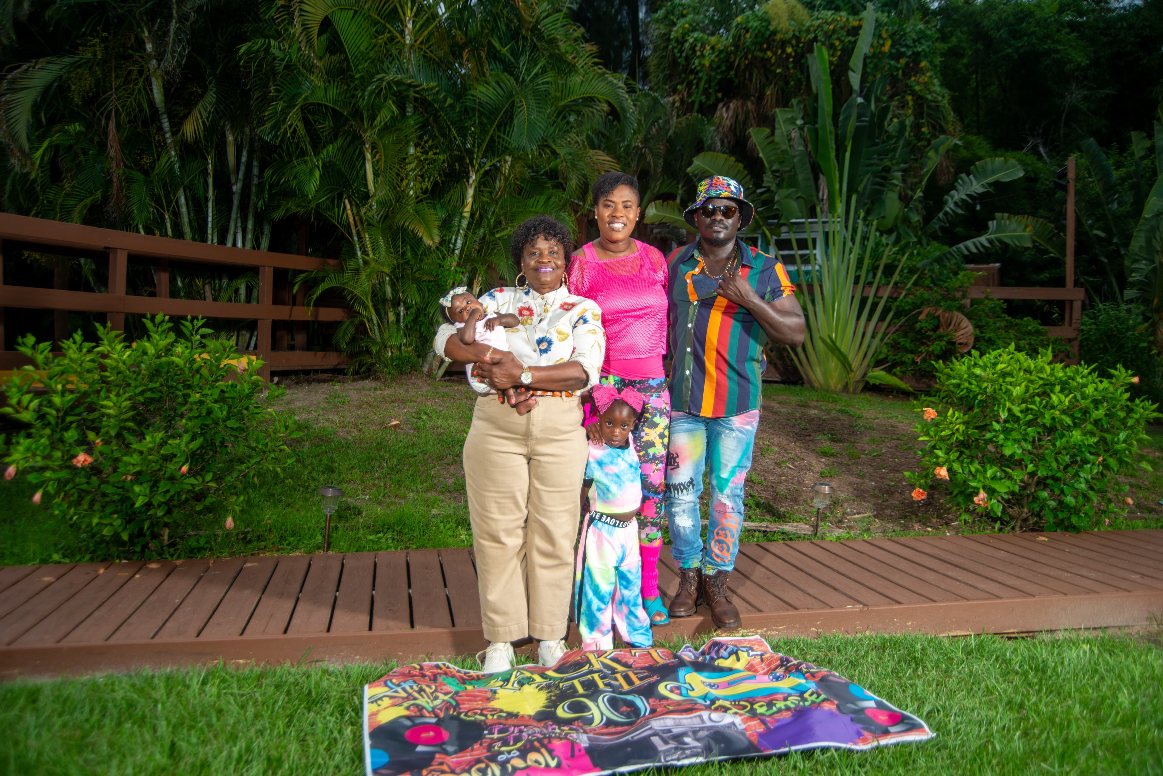 Multi-generational family portrait with a baby, outdoors