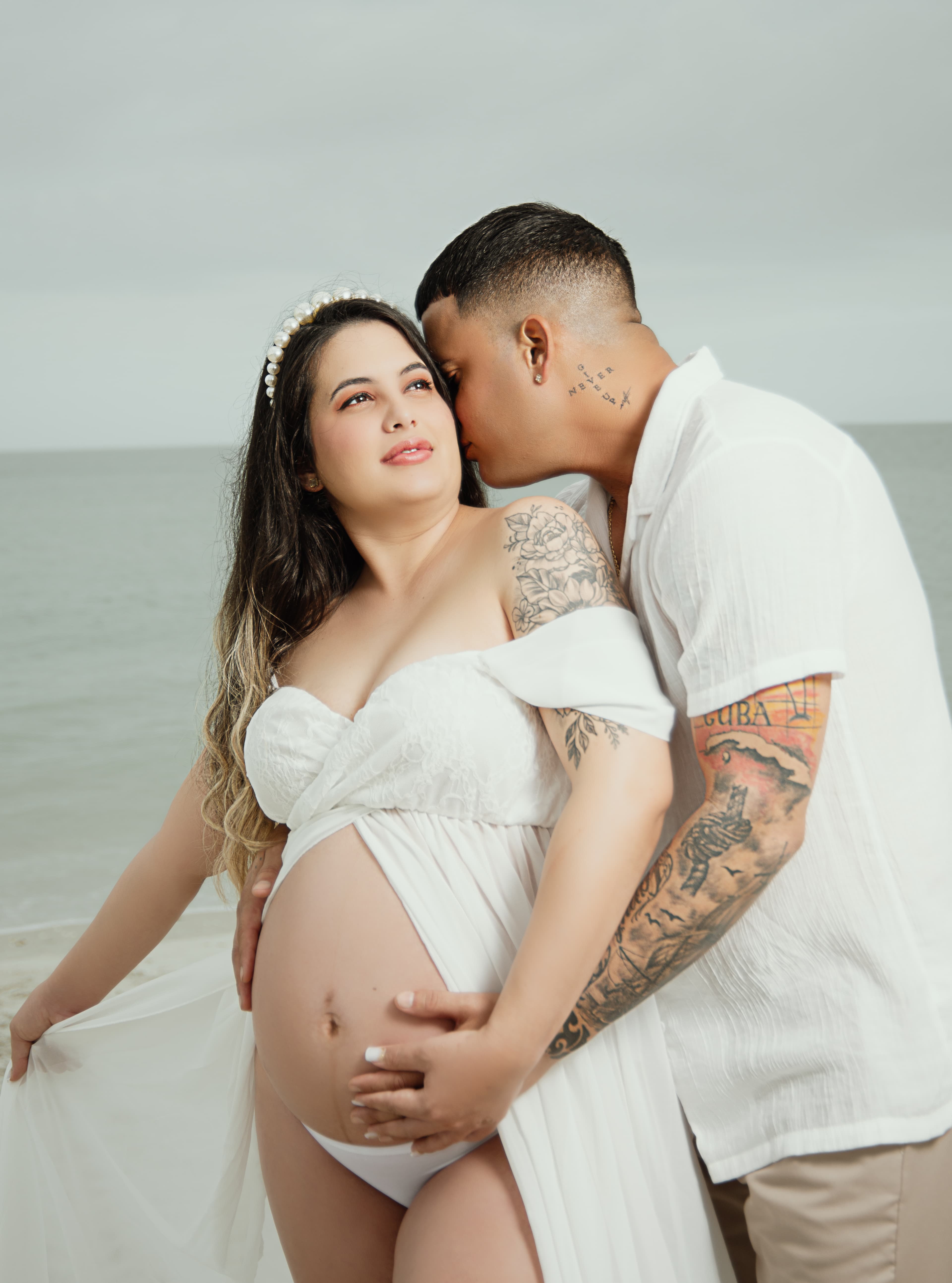 Maternity couple portrait on the beach at sunset