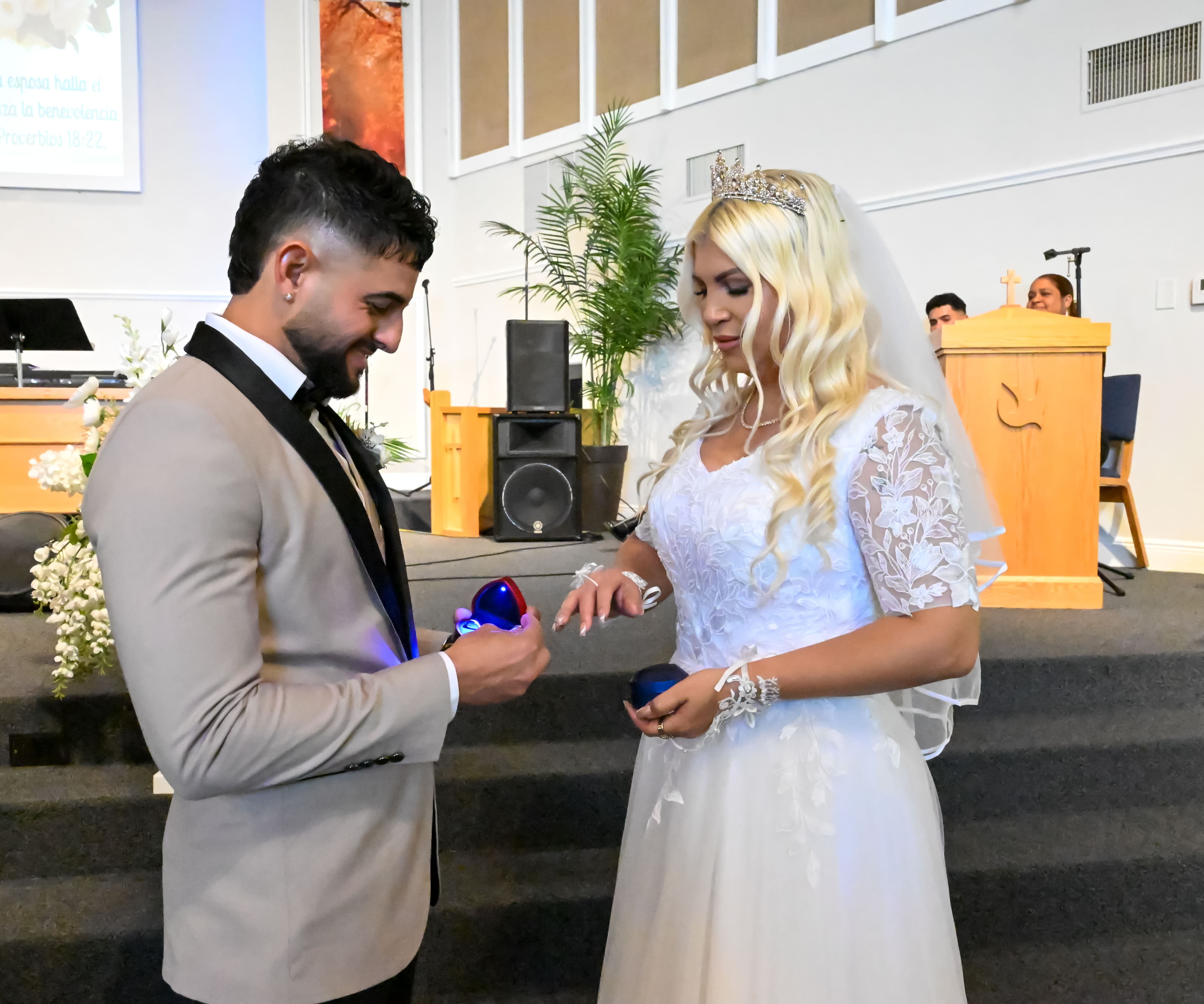 Groom placing the ring on his bride during the ceremony